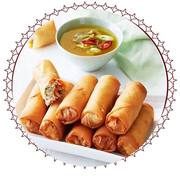 Crispy golden spring rolls with a savory filling, served with a bowl of dipping sauce.